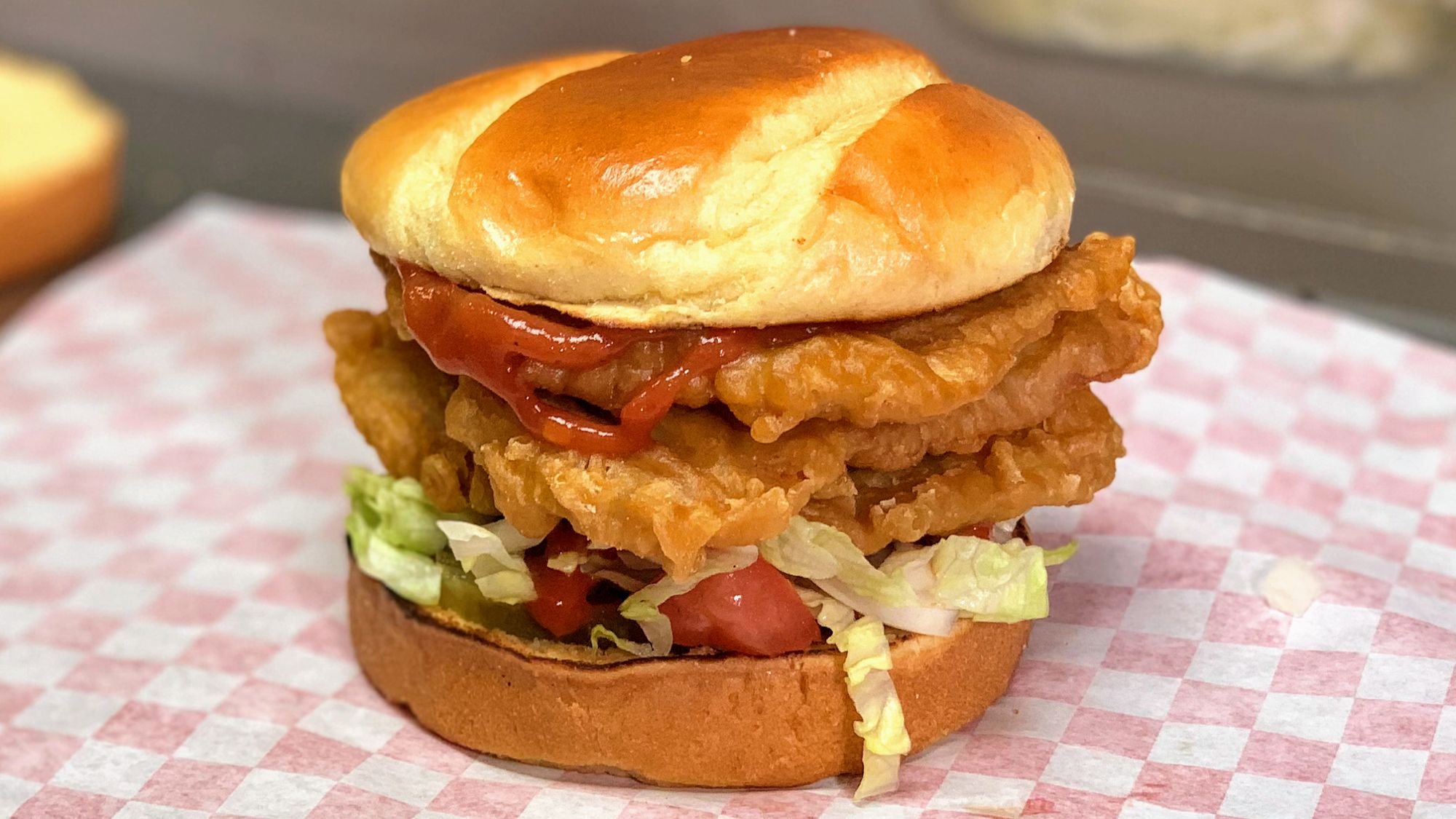 The tenderloin, stacked and sauced, on red check paper